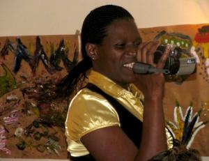 A woman at the FTX training learns to use a digital camera