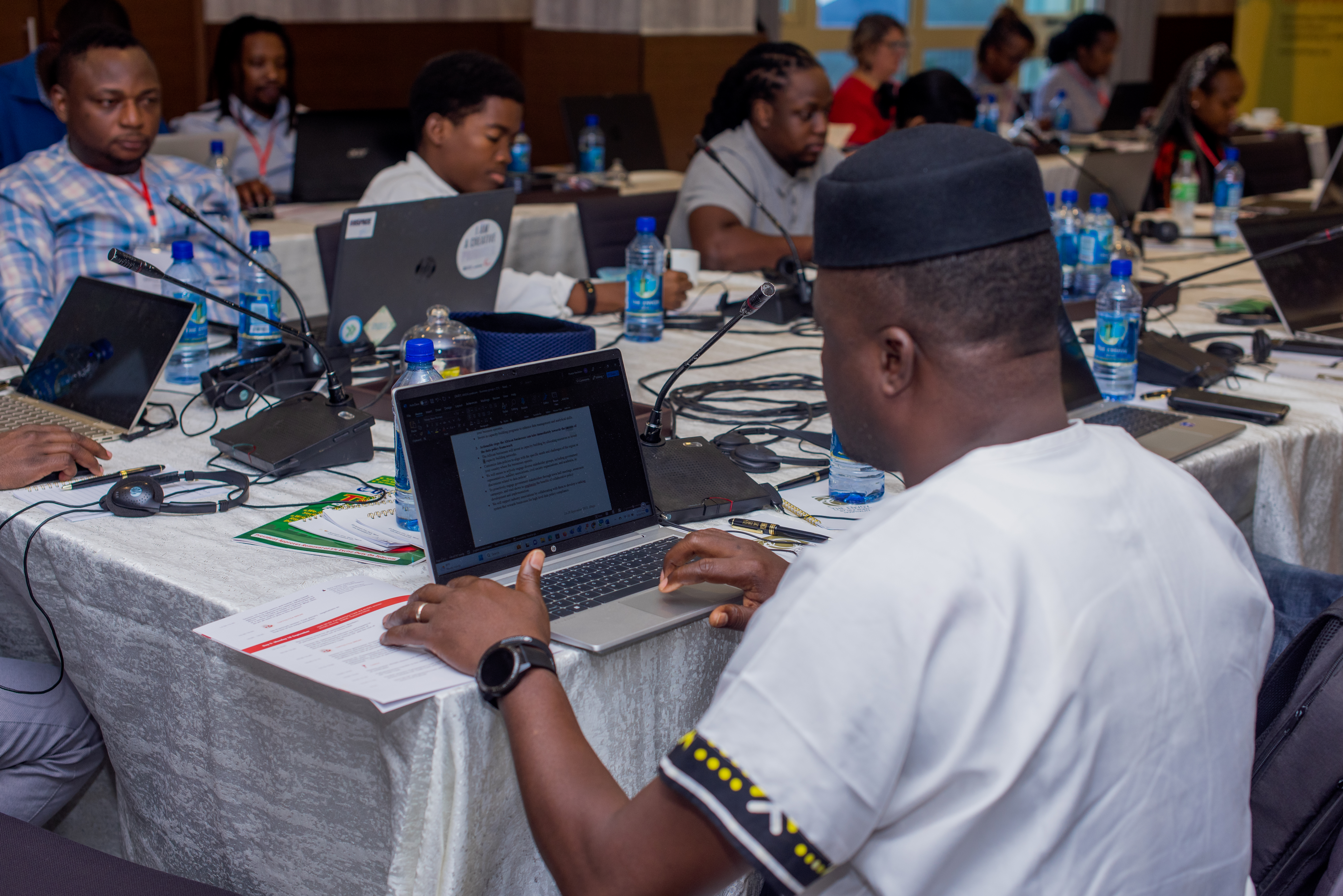 Photo of AfriSIG 2023 participants working on their laptops.