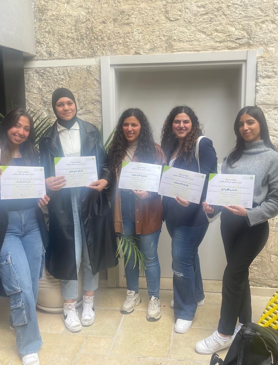 Participants of 7amleh's digital security training show their completion certificates.