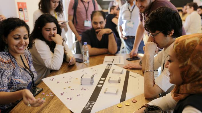 Bread&Net 2018 attendees playing PROXY, during a session testing the board game designed to teach Lebanese youth about online mobile privacy and security. Photo: Muriele Honein/SMEX)