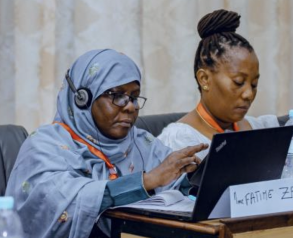 Two African women sitting at a table during this year's AfriSIG activities
