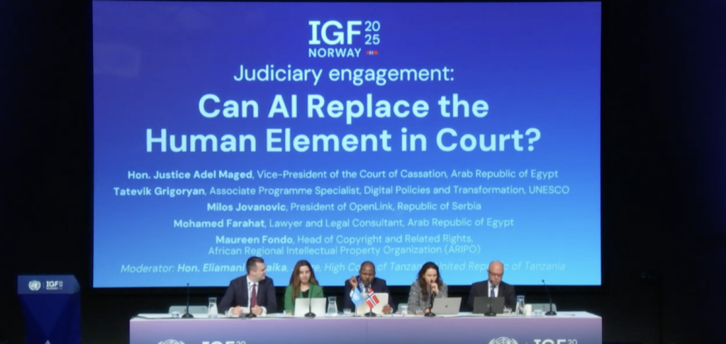 Five people sitting side by side at a table during an IGF session that year.