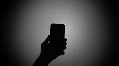 Silhouette of a person holding a smartphone image linking to Security at what cost? Mobile data shutdown pushes Pakistan’s Balochistan further into isolation 